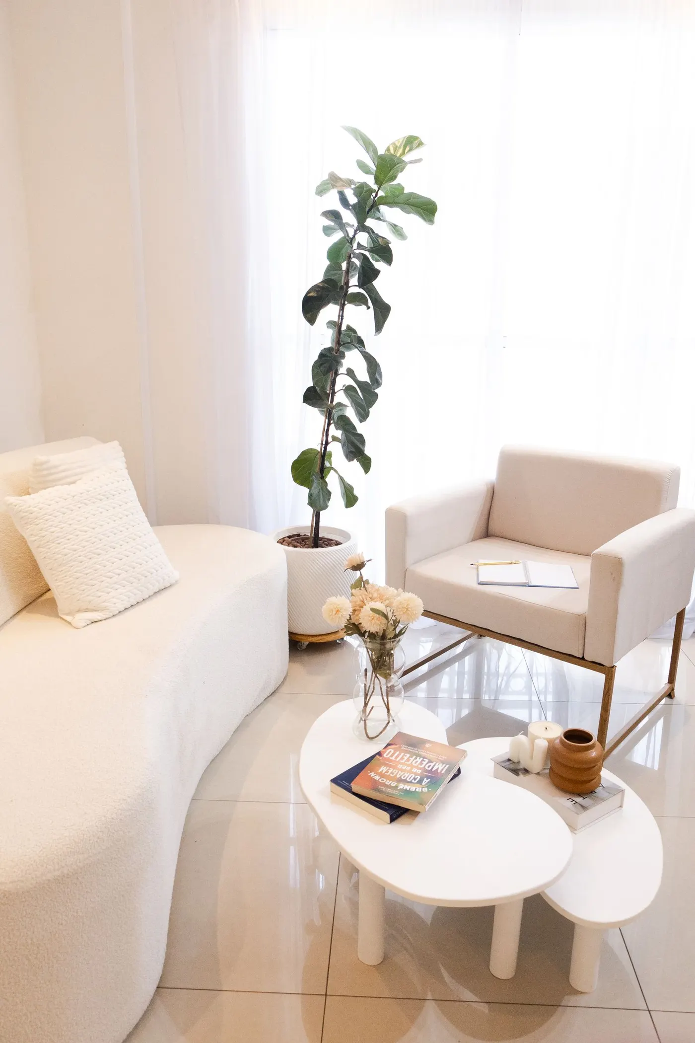 Calm, tidy living room with a cream sofa and armchair